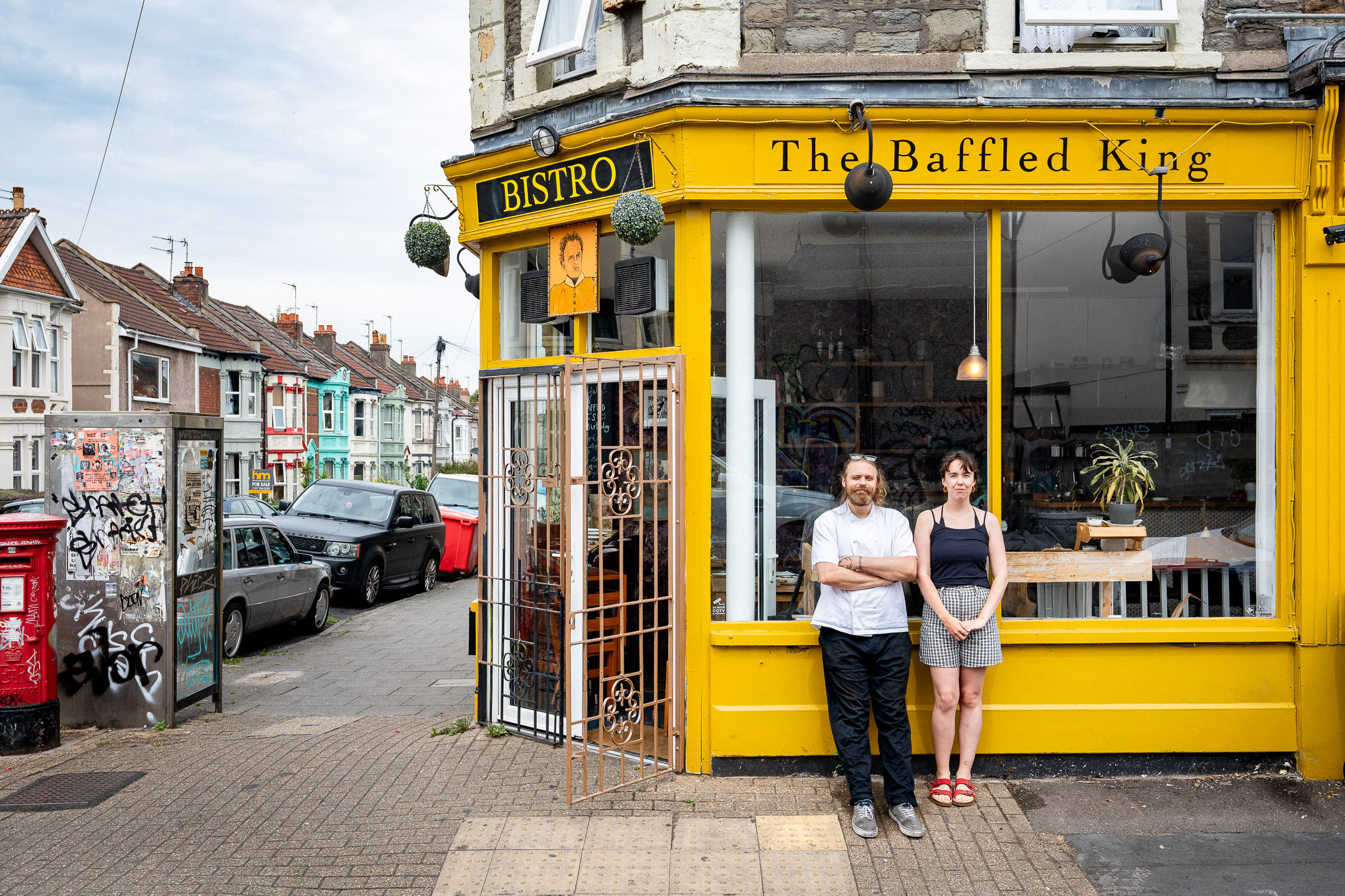 Business photographer Bristol — owners outside The Baffled King bistro on a Bristol street corner