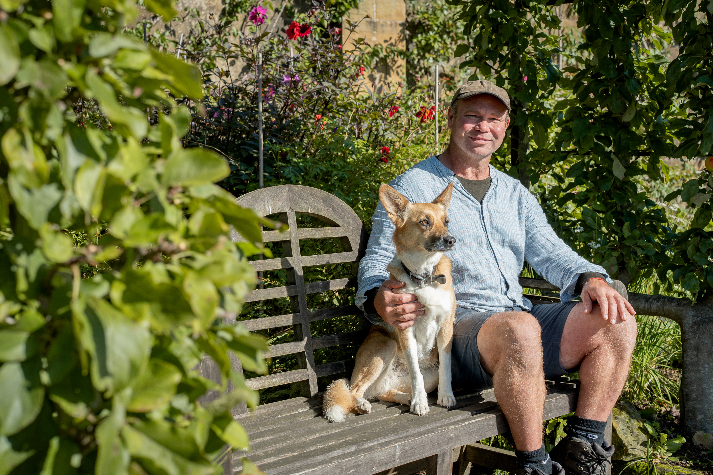 Business photographer London — Olly Hunter with his dog on a London garden bench