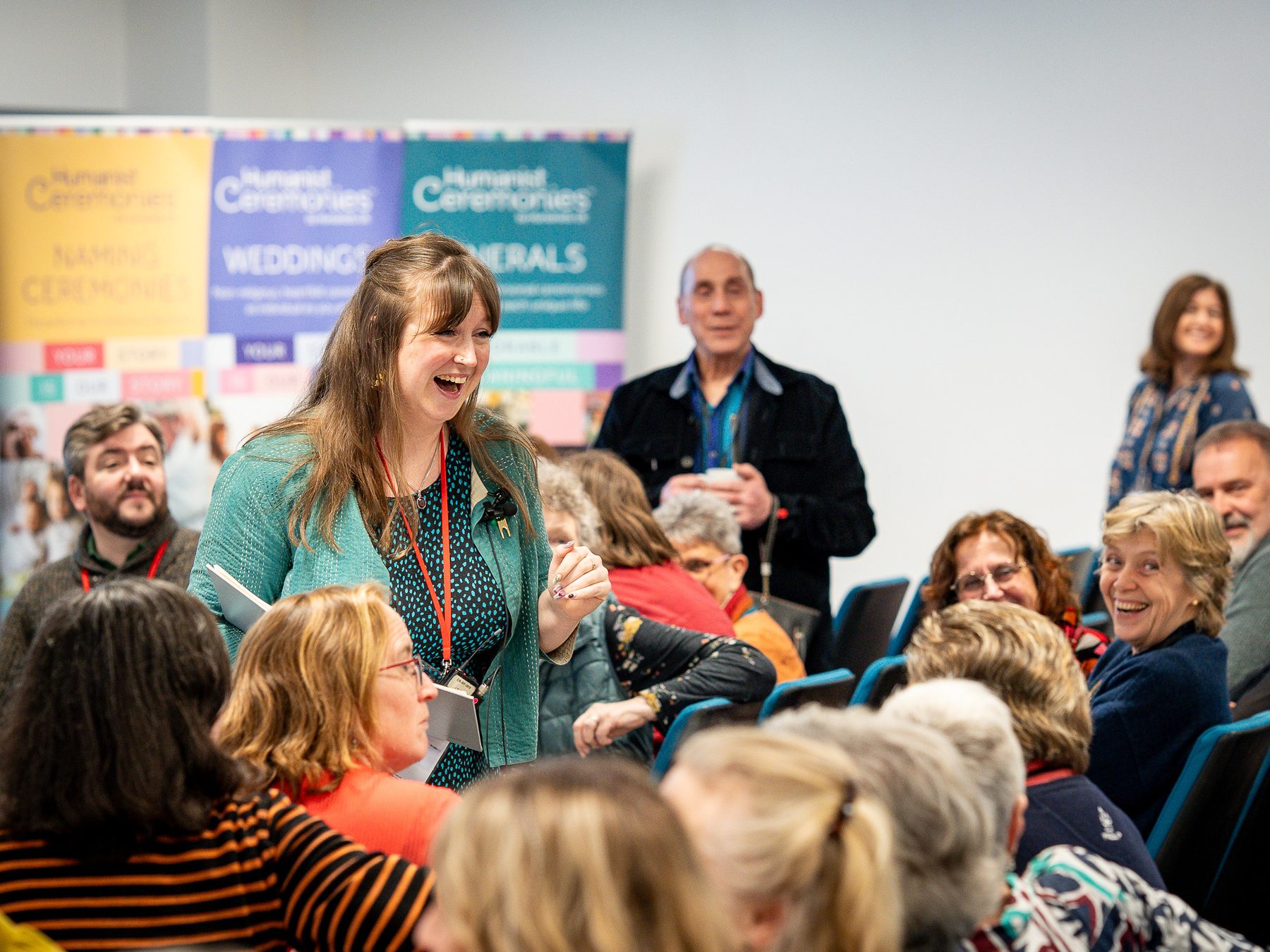 Speaker engaging a seated audience at a conference