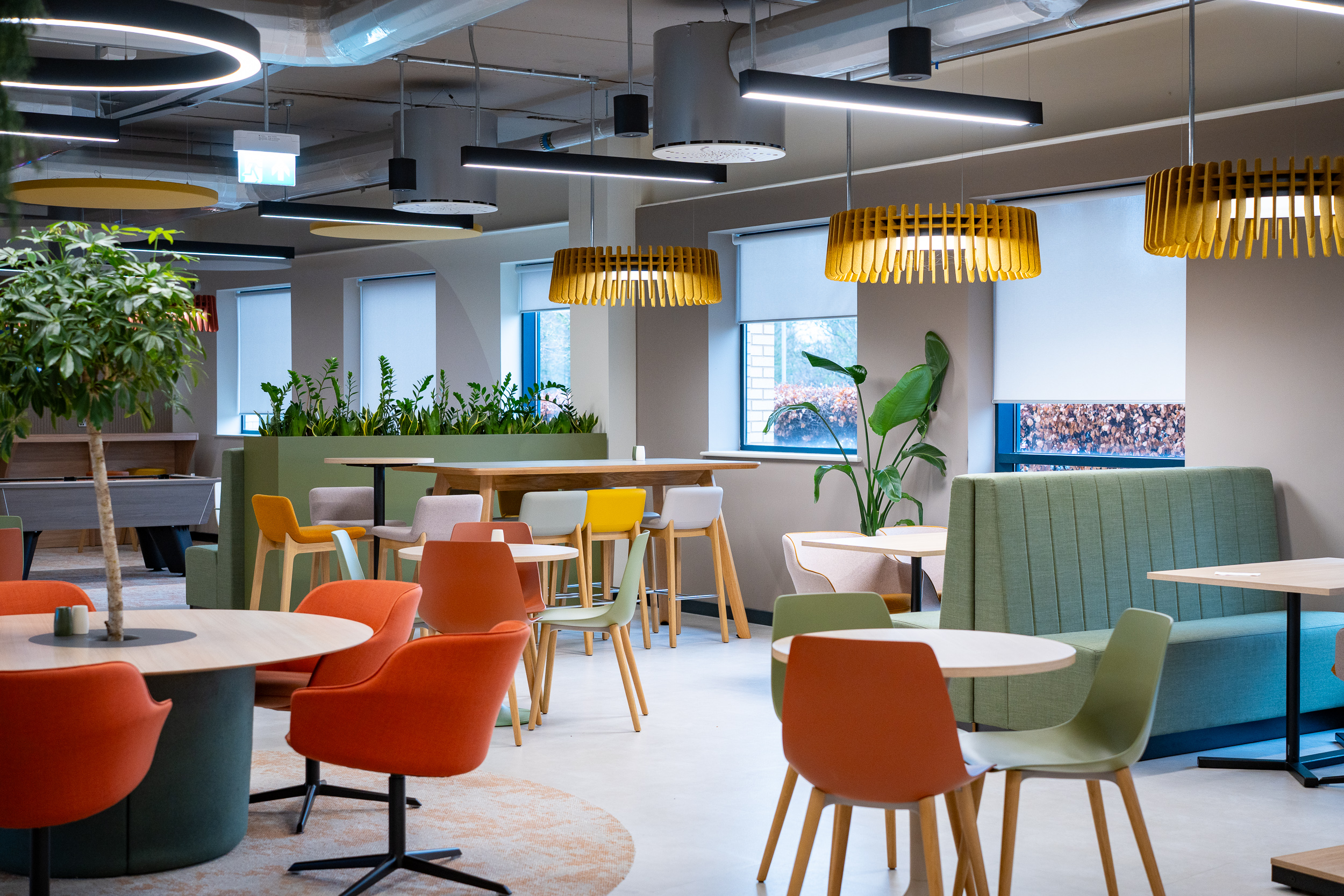 Modern office lounge with statement pendants, workspace interior photography
