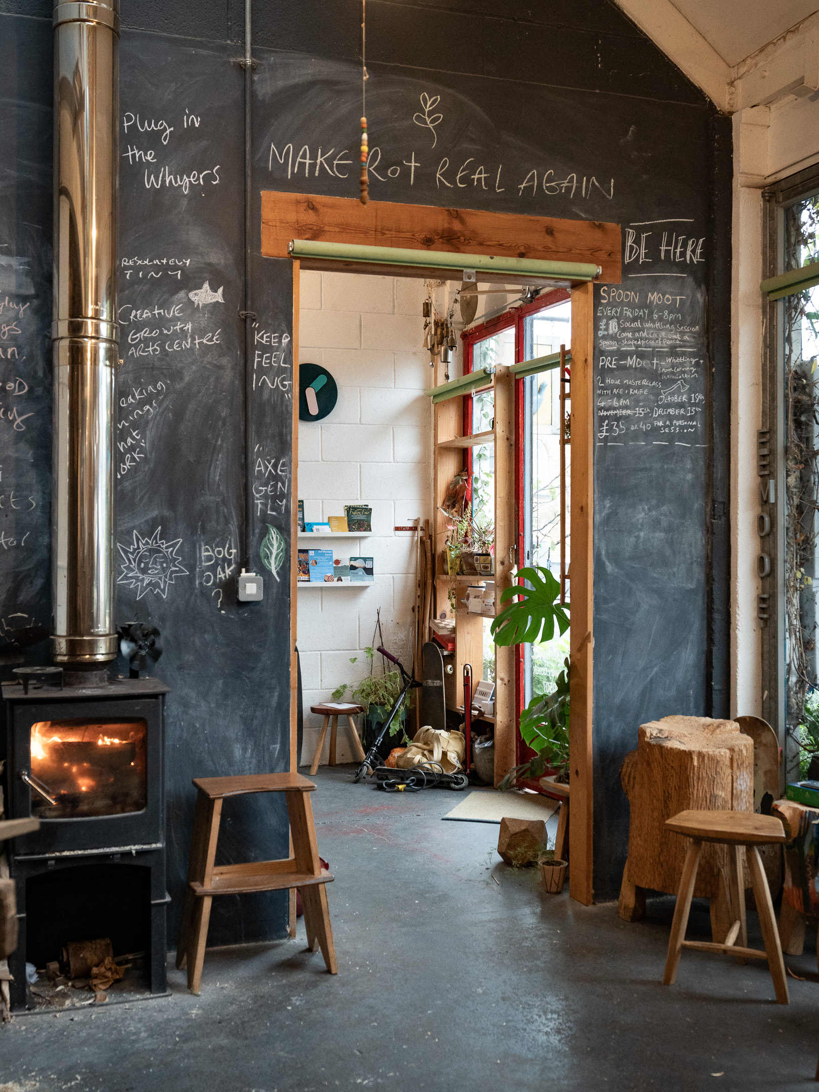 Plant-filled hospitality interior with wood-burner, café photography