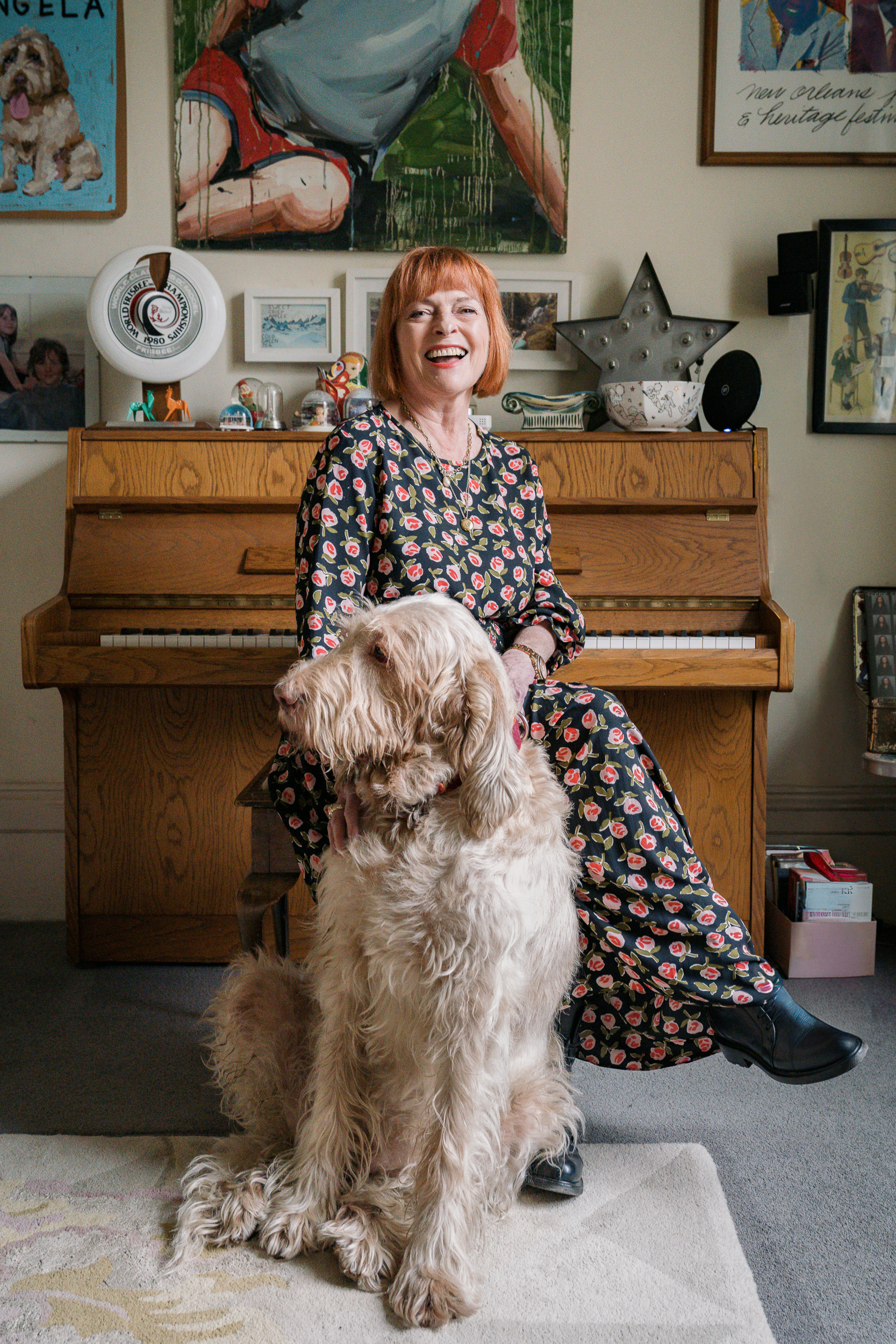 Personal brand portrait of a professional woman with her golden labradoodle at home