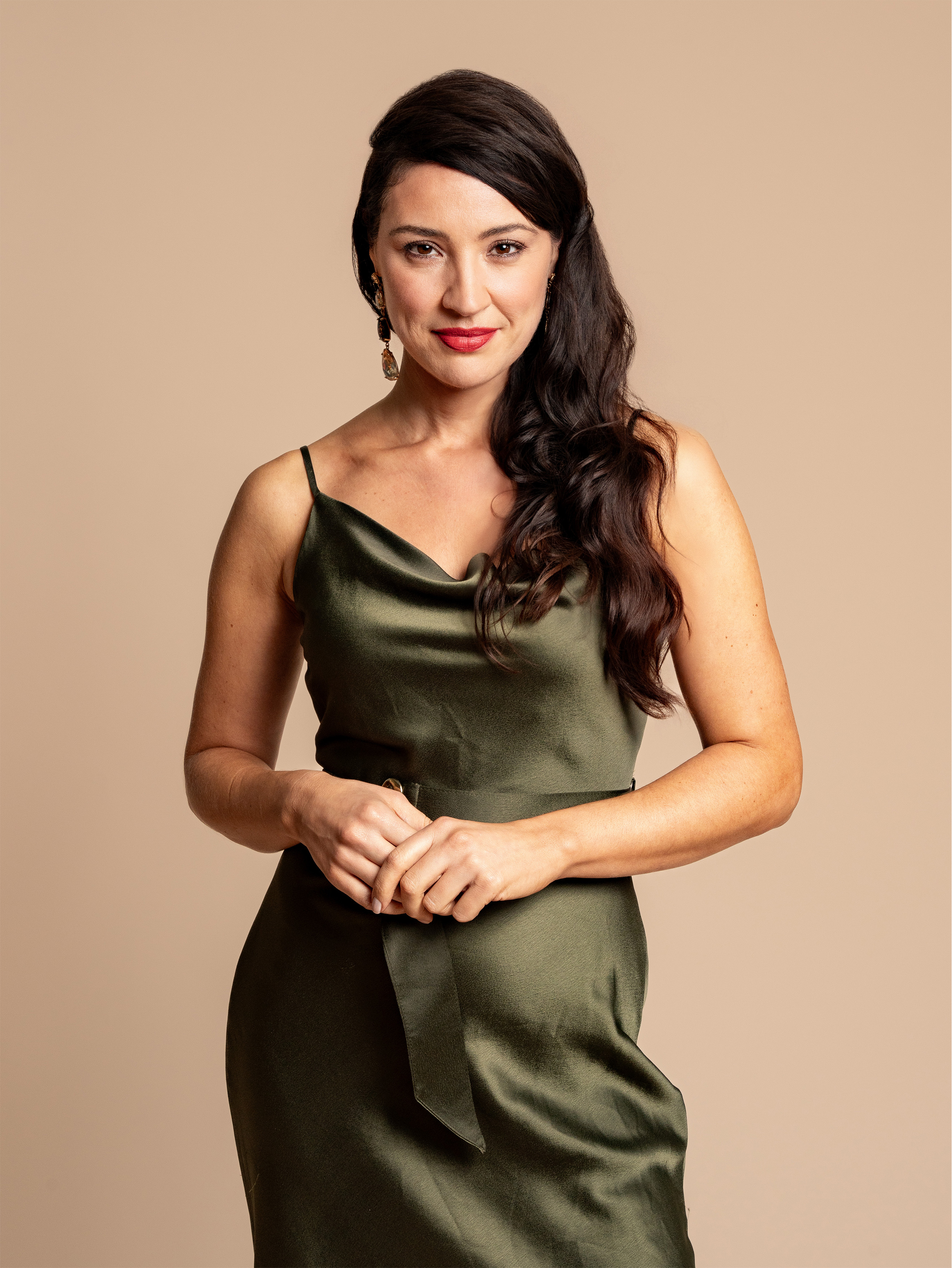 Studio personal brand portrait of a woman in a green silk dress