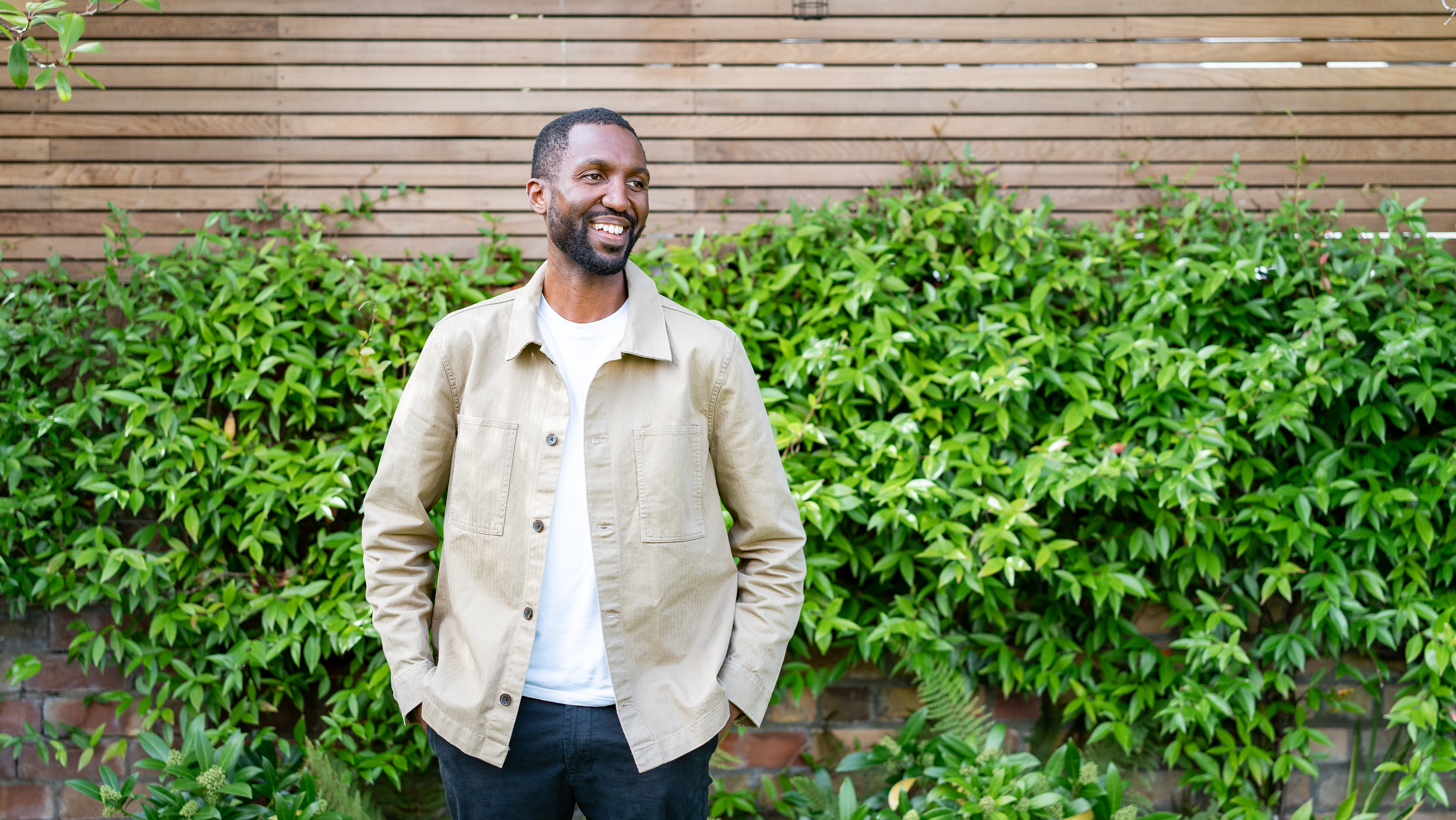 Male founder personal brand portrait in greenery, natural light